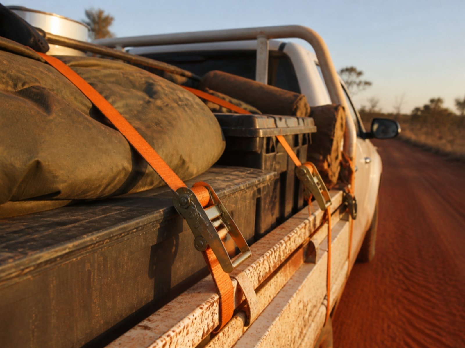 Ratchet straps holding gear in a ute tray